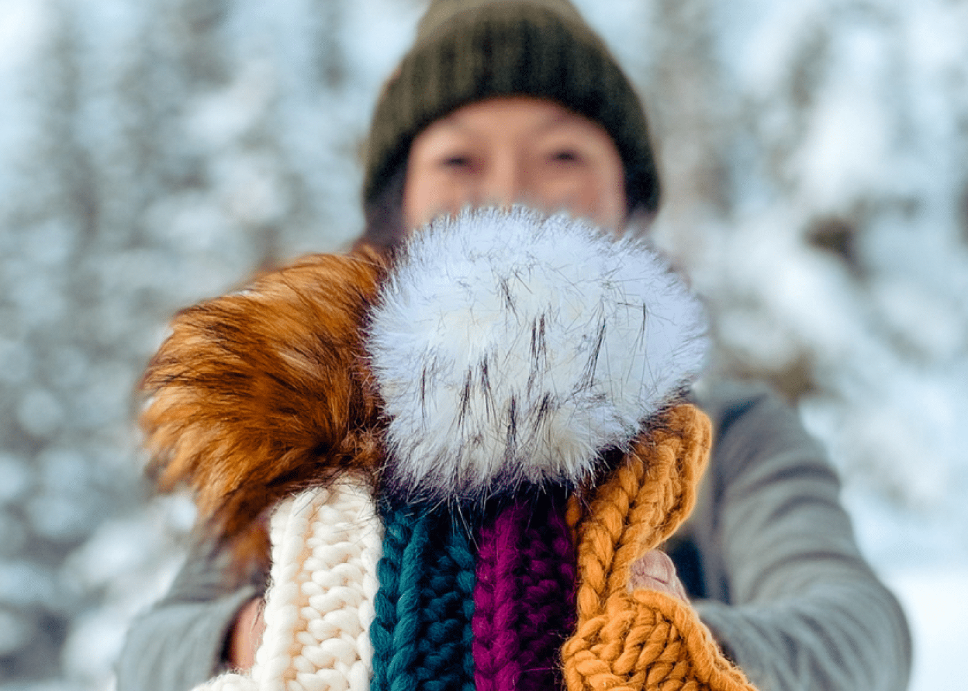 Chareen Leong Schwarz holding up a handmade beanie