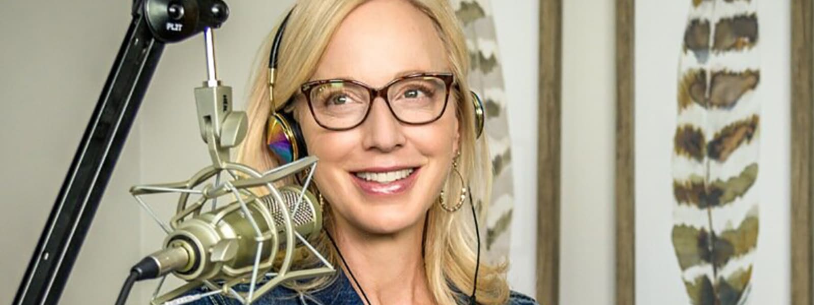 Woman doing a podcast smiling with microphone