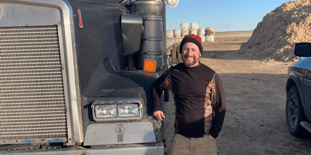 Serge, a man standing next to a large truck