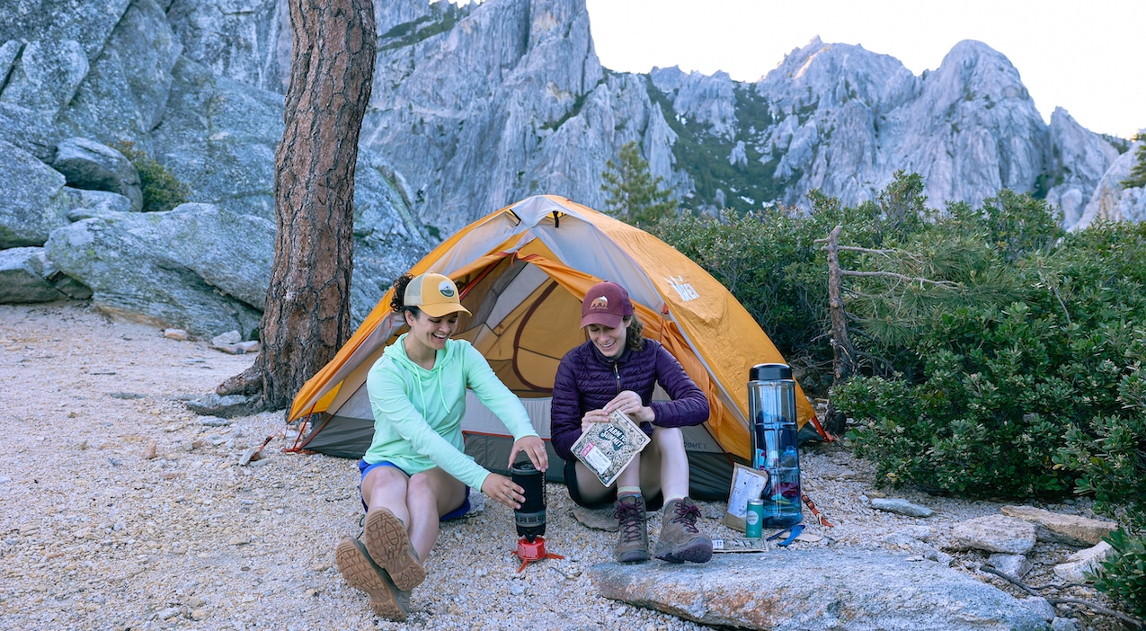 two hikers enjoying farm to summit meals in the mountains while camping
