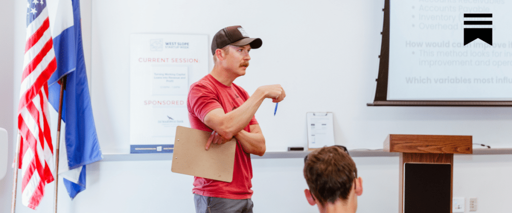 man leading a discussion in front of a classroom
